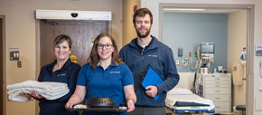 Concierges helping a patient in their hospital room