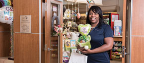 Concierge buying a gift with a balloon