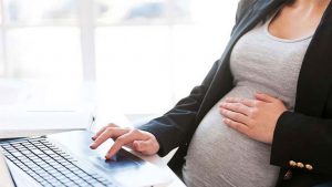 pregnant woman working at a computer