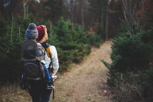 woman hiking w/toddler in backpack