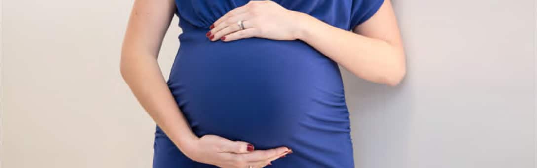 woman holding her pregnant belly