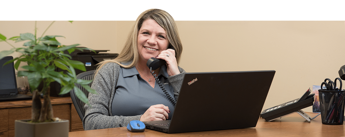 woman at a desk talking on a phone