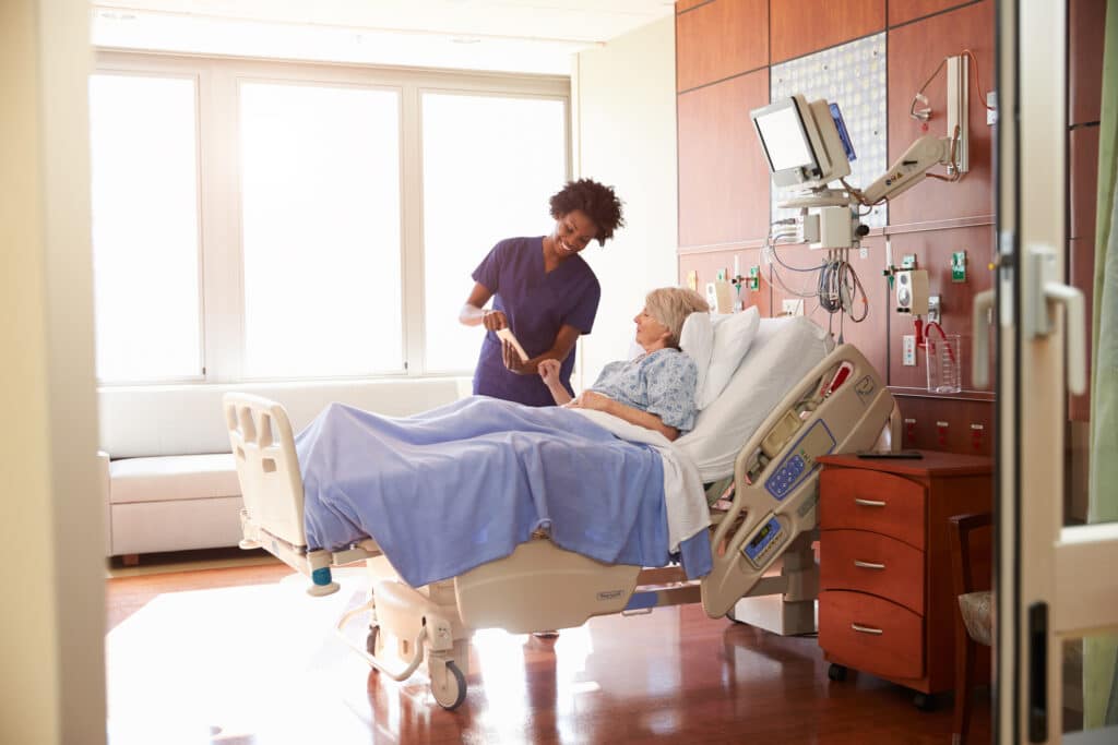 Patient Concierge Talks To Senior Patient