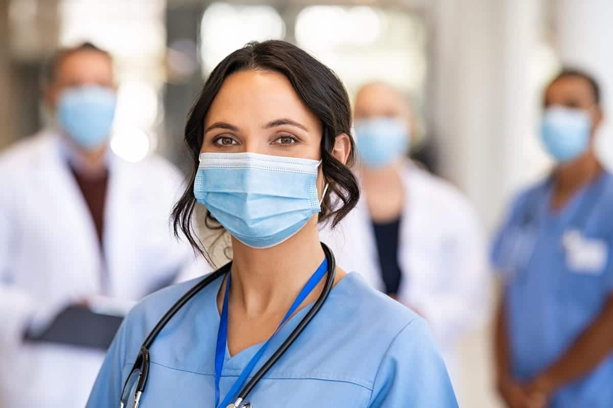 Image of a registered nurse at a hospital wearing a surgical mask.