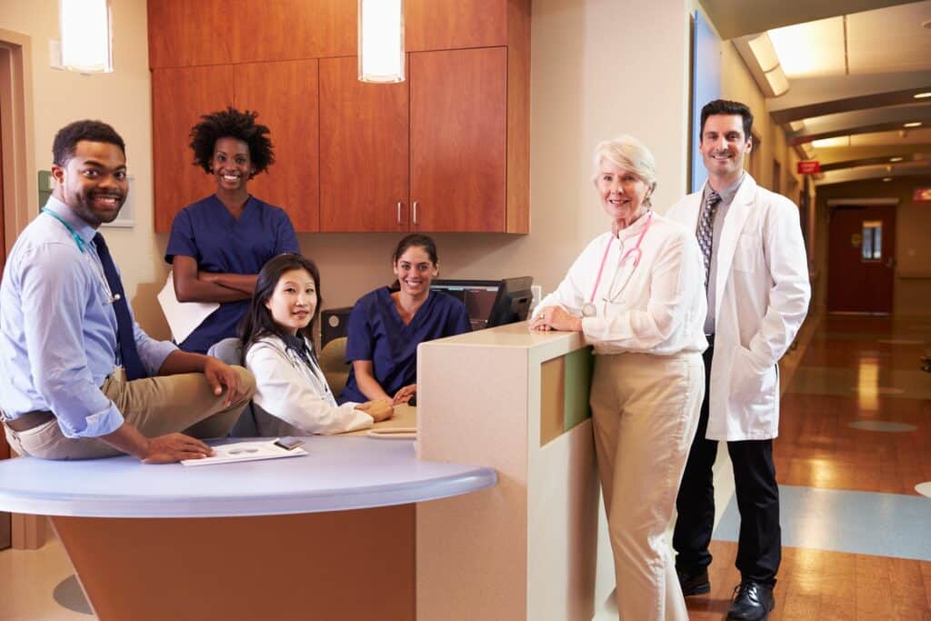 Happy hospital healthcare staff photographed together smiling.